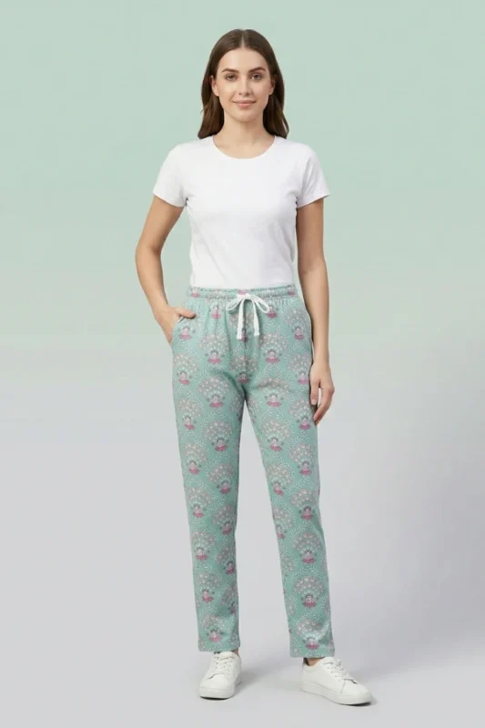 Full-body image of a model wearing elegant teal mandala print women's pajamas with intricate designs, drawstring with tassels, and hands in pockets.