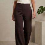 Woman standing modeling high-waisted espresso brown wide-leg relaxed fit imported cotton trousers