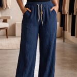 Woman wearing midnight navy blue vertical stripe wide leg cotton blend pajama with drawstring waist