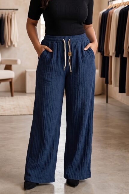Woman wearing midnight navy blue vertical stripe wide leg cotton blend pajama with drawstring waist