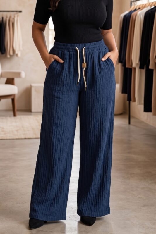 Woman wearing midnight navy blue vertical stripe wide leg cotton blend pajama with drawstring waist