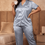 Woman holding teacup wearing powder blue satin co-ord loungewear set