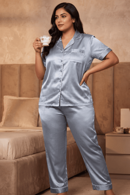 Woman holding teacup wearing powder blue satin co-ord loungewear set