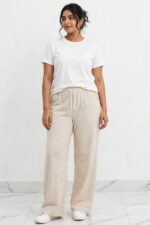 Model wearing beige oatmeal sand relaxed wide leg lounge pajama pants