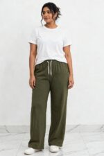 Model wearing olive green relaxed wide leg lounge pajama pants with pockets