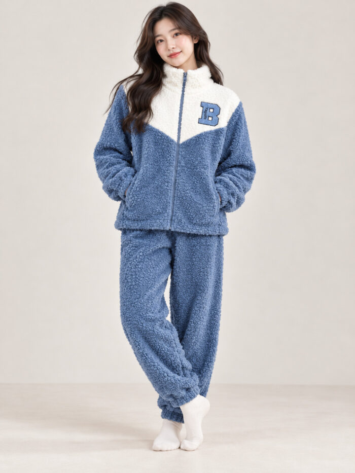 Woman wearing a blue and cream plush winter co-ord set with a zip-front top and matching pyjamas