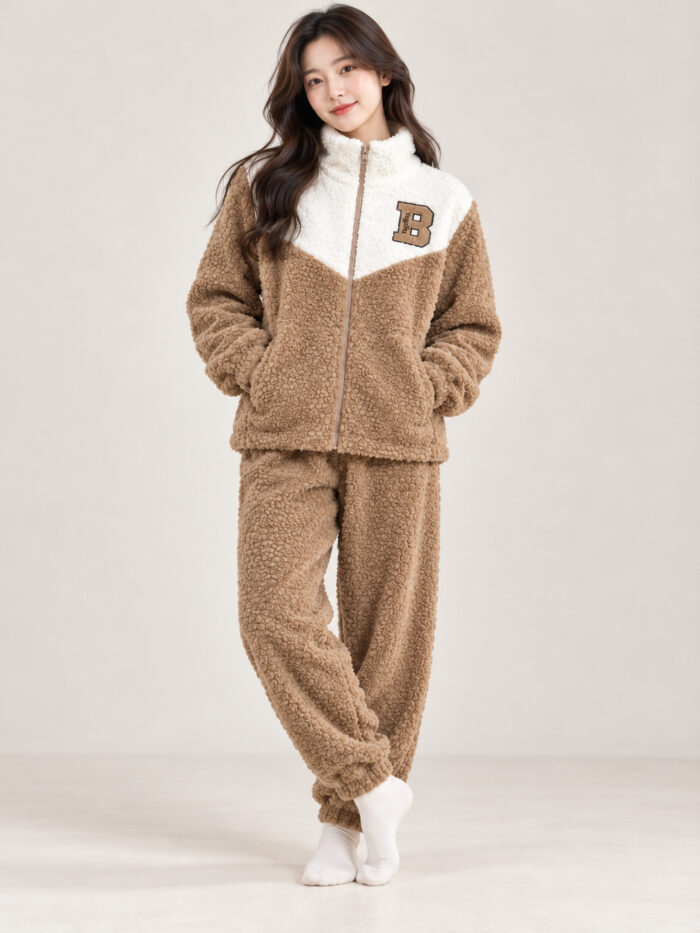 Woman wearing a brown and cream plush winter co-ord set with a zip-front top and matching pyjamas