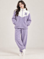 Woman wearing a lavender and cream plush winter co-ord set with a zip-front top and matching pyjamas